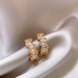 Elegant gold earrings with sparkling zircons